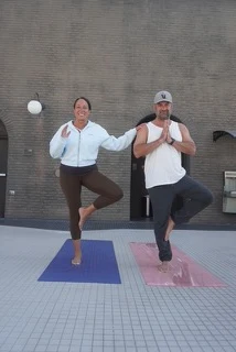 Two students balancing in tree pose during a Ren Zen class at the Renaissance Reno Downtown Hotel